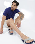 Styled shot: navy blue v-strap flipflops paired with shorts and casual t-shirt.