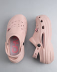Pair of pink clogs on a gray background which is Water-resistant and quick-dry