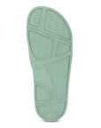 Close-up of a green sandal sole on a white background