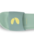 Green slide sandal with yellow logo on a white background