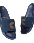 A navy blue and orange men's slider sandal with a single strap and a navy blue sole, featuring the ErgoX Plus footbed and Chupps logo.
