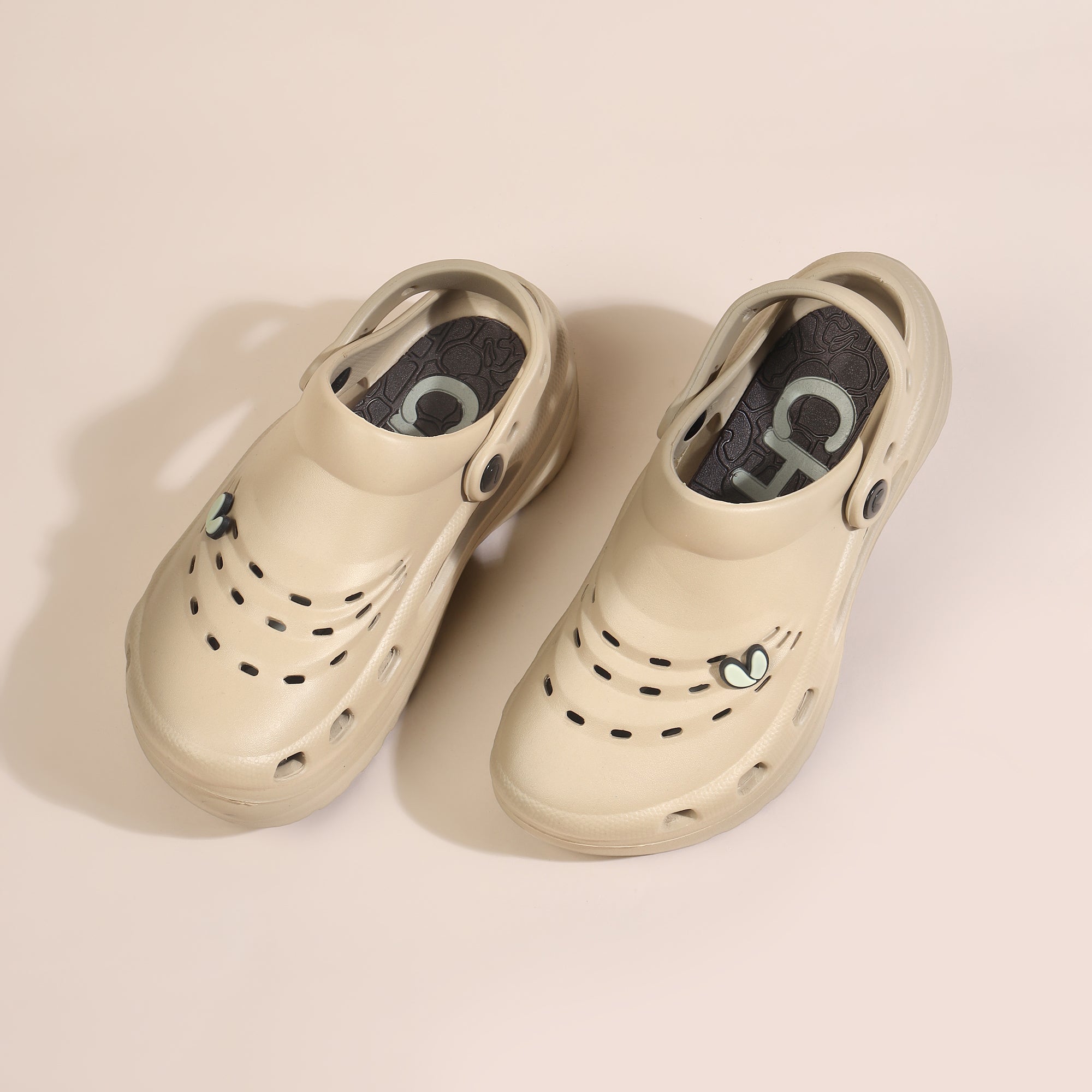 Beige EVA clogs with ventilation holes, thick outsole, and heel strap
