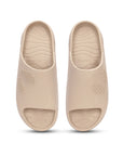 Pair of beige Chupster slides with dotted pattern and textured soles on a white background