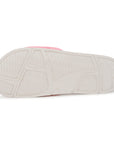 White sandal sole with pink heel tab on a white background