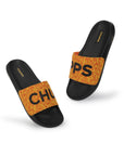 chupps yellow slippers with black text and fire design .