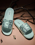 Chupps Tumble men’s slider with dark green strap and light green sole in playful, modern design which is comfortable sliders for casual streetwear.