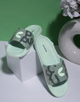 Green slides with camouflage pattern and brand logo on a white and green background .Modern men’s green sliders with graphic upper .
