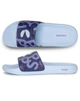 Pair of light blue slides with purple strap and 'CHUUPS' branding on a white background