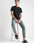 Urban Edge black sliders styled with sporty cargo and black T-shirt.