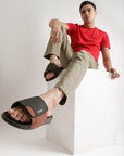 Styled image: sliders with beige cargo and red t-shirt for casual outdoor wear.