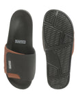 Outsole shot of black tan sliders showing slip-resistant tread.