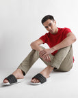 Lifestyle shot of sliders styled with khaki pants and red t-shirt