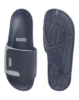 Outsole shot showing slip-resistant tread on navy & grey sliders.