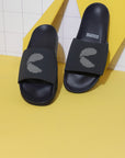 Close-up of dotted strap pattern, slider resting on a yellow cardboard juxtaposed against a white background