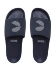A pair of navy blue dot-patterned sliders for men with a single strap and a flat sole.