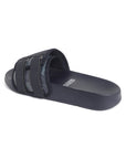 Side view of navy blue camo sliders highlighting gripped footbed and adjustable Velcro strap.