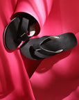 Curve Black V-Strap top view showing URO Foam footbed and dotted sole on a red craft paper