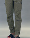 Person walking indoor wearing grey and black quilted sliders