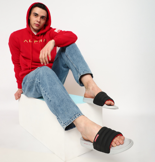 Chupps men’s casual black sliders with cushioned straps and light grey sole, styled with jeans and hoodie – comfortable open footwear for everyday wear.