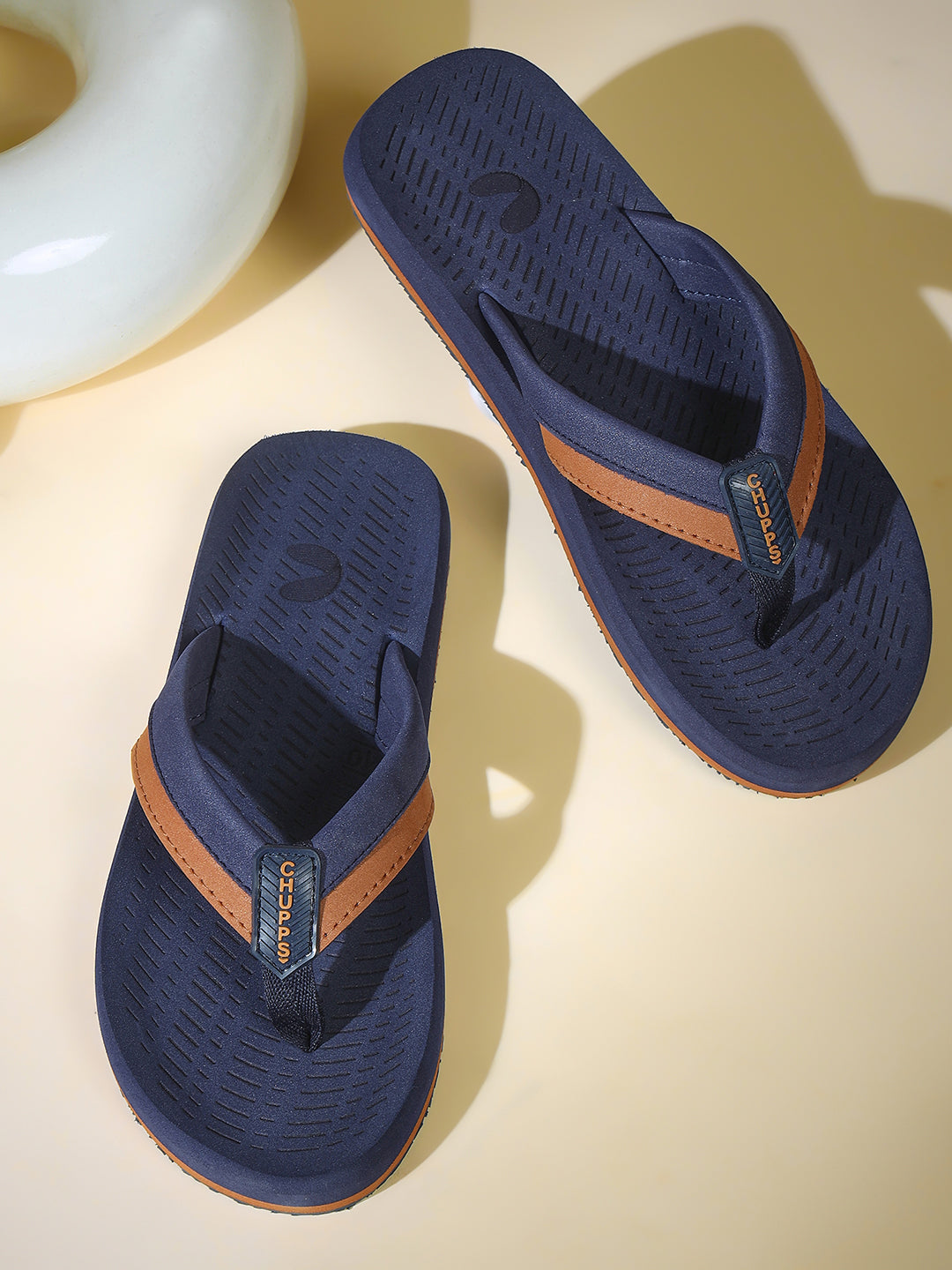 Holt sandals placed casually on a tiled floor
