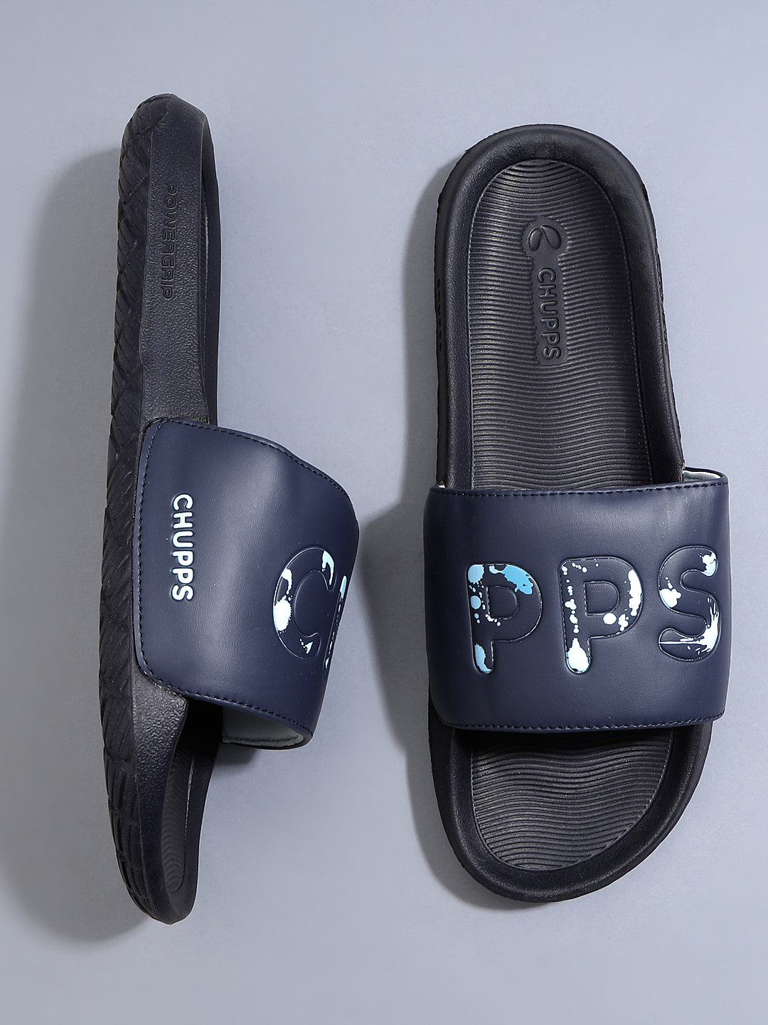 Top-down view of navy Drip sliders with tone-on-tone streetwear design
