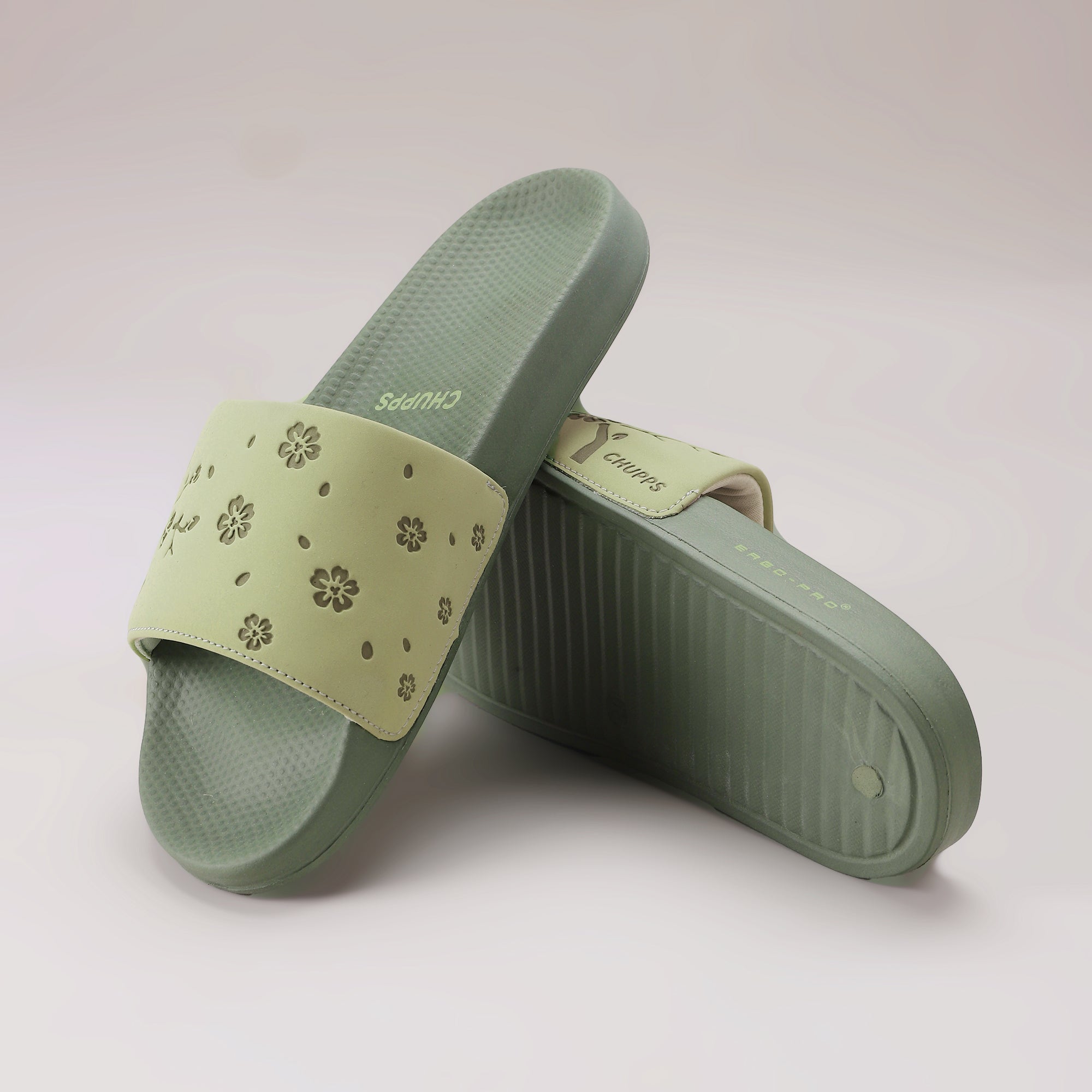 Dynamic view of Pista Green sliders highlighting slim strap and minimal profile.