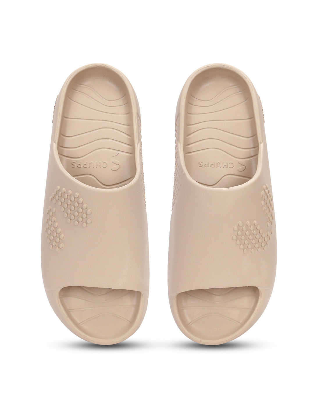 Pair of beige Chupster slides with dotted pattern and textured soles on a white background